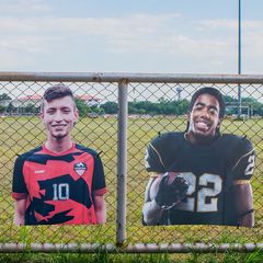 Custom sports player cutouts on fence