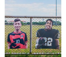 Custom sports player cutouts on fence