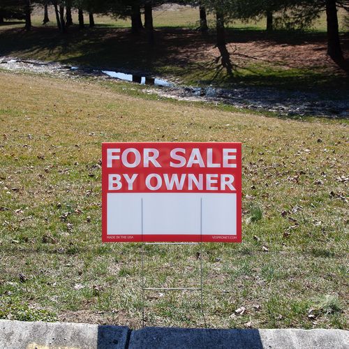 Sign staked into the ground in front of a yard