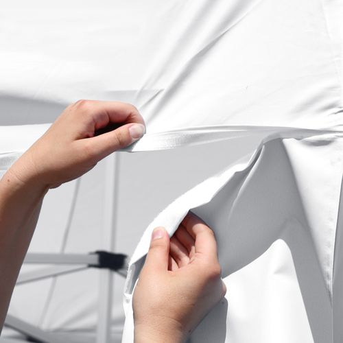 Tent wall attaches to canopy via hook-and-loop fasteners